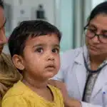 Measles symptoms and rash in a child during medical examination
