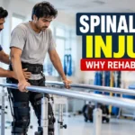 Patient practising supported standing with a physiotherapist during spinal cord injury rehabilitation.